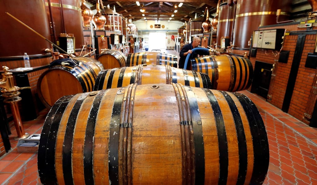An employee works on barrels of distillate, the “Eau de vie”, during a double distillation at the distillery of Courvoisier house in Chateauneuf-sur-Charente near Cognac, France. Photo: Reuters