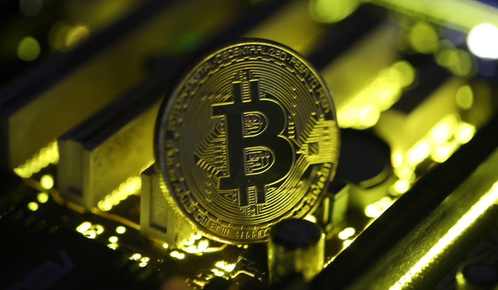 A copy of bitcoin standing on PC motherboard. Photo: Reuters