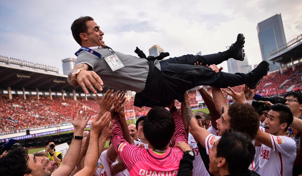 Tianjin Quanjian players give head coach Fabio Cannavaro the ‘bumps’ as they celebrate a win against Guangzhou Evergrande. Photo: AFP Tianjin Quanjian players give head coach Fabio Cannavaro the ‘bumps’ as they celebrate a win against Guangzhou Evergrande. Photo: AFP