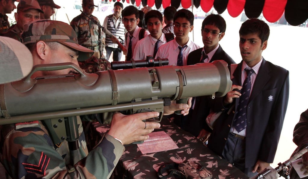 An Indian army soldier demonstrates the functions of a self-propelled rocket launcher to school children during an exhibition in Calcutta. In the past decade, India has become the world’s largest importer of weapons. Photo: AP