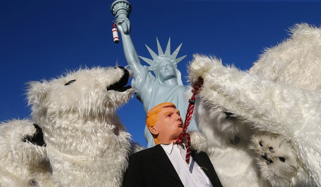 A protester wearing a mask of US President Donald Trump stands with others dressed as polar bears during a demonstration two days before the start of the COP 23 UN Climate Change Conference in Bonn, Germany, on November 4. Photo: Reuters