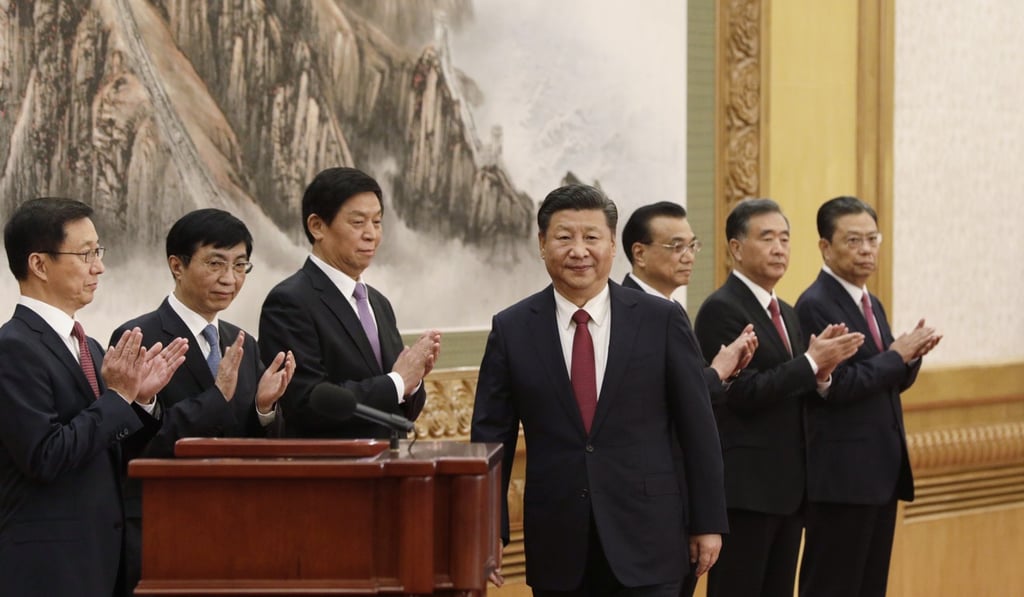 President and Communist Party chief Xi Jinping (centre) is applauded by members of the new Politburo Standing Committee (from left) Han Zheng, Wang Huning, Li Zhanshu, Premier Li Keqiang, Wang Yang and Zhao Leji, at the Great Hall of the People in Beijing on October 25. No women have ever made it to the powerful committee. Photo: Bloomberg