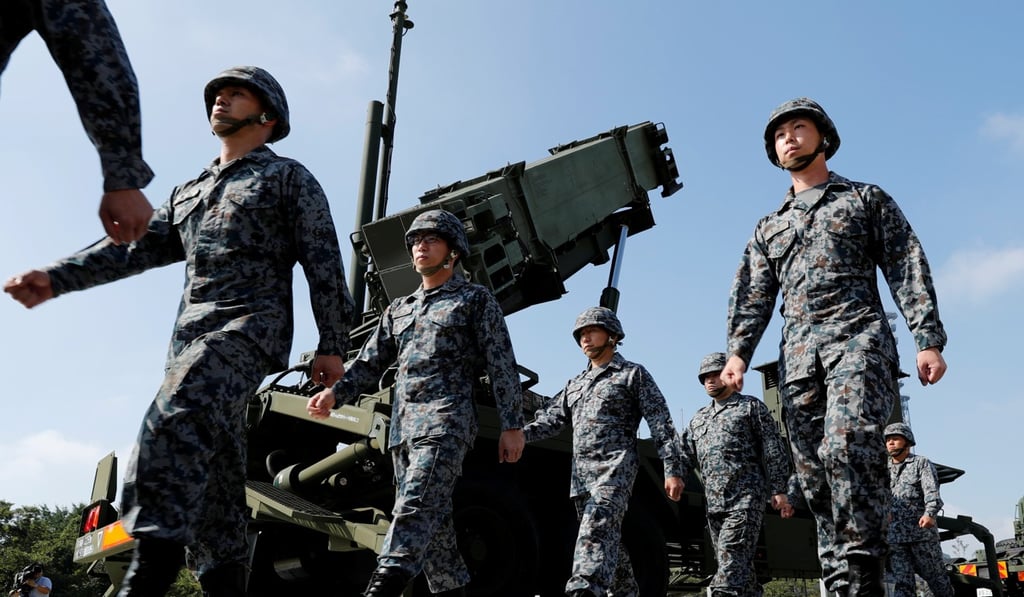 Japan Self-Defence Force soldiers walk past a Patriot Advanced Capability-3 (PAC-3) missile unit. Photo: Reuters