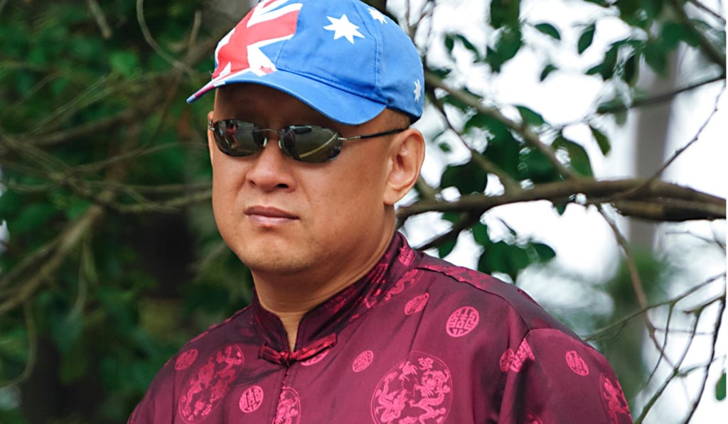 A man wears a Chinese-style top and a cap adorned with the Australian flag, on Australia Day 2017, in Berrima, New South Wales, Australia. Picture: Alamy