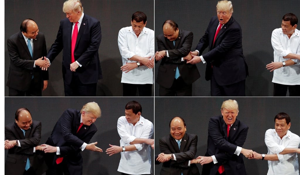 US President Donald Trump registers his surprise as he realises other leaders, including Vietnam's Prime Minister Nguyen Xuan Phuc and President of the Philippines Rodrigo Duterte, are crossing their arms for the traditional ‘Asean handshake’. Photo: Reuters