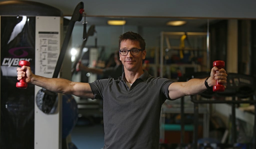 Physiotherapist Malcolm Minns demonstrates lateral raises, an exercise that can alleviate the pain of frozen shoulders. Photo: Xiaomei Chen