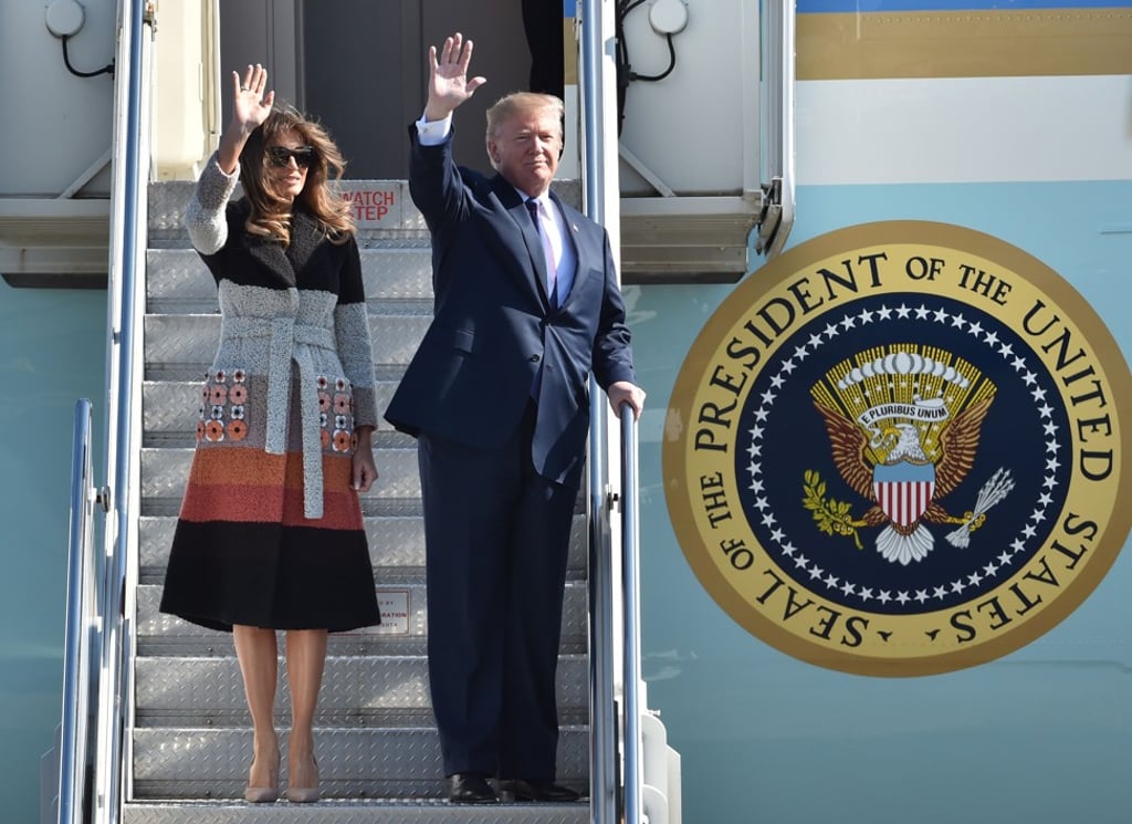 The Trumps wave as they arrive at Yokota Air Base in Japan. Photo: AFP