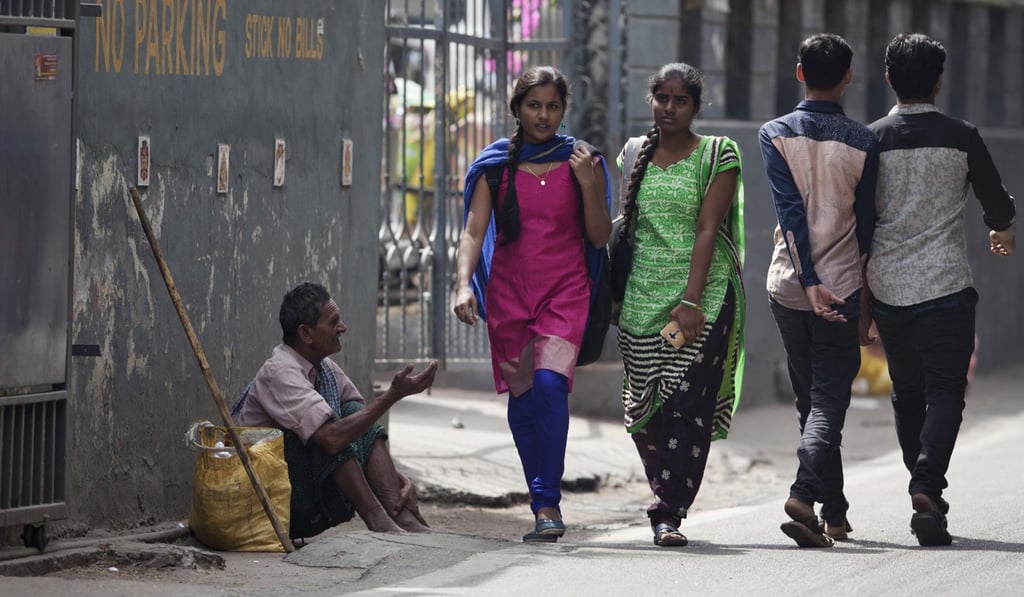 A man begging on a street in Hyderabad, India. Photo: AP A man begging on a street in Hyderabad, India. Photo: AP
