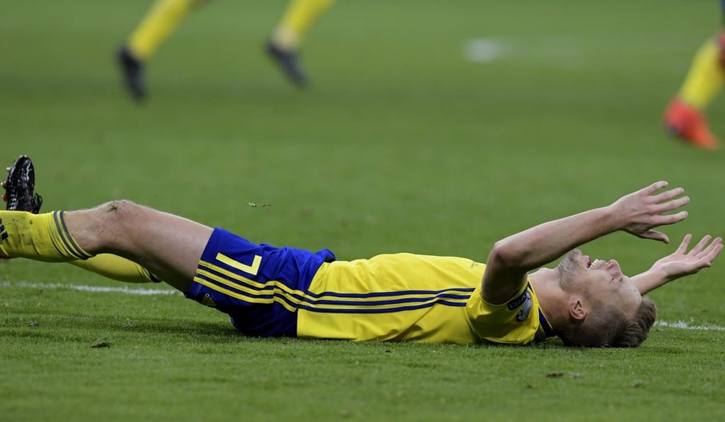Sweden midfielder Sebastian Larsson falls to the ground in celebration after they knocked out Italy in a World Cup play-off. Photo: AFP Sweden midfielder Sebastian Larsson falls to the ground in celebration after they knocked out Italy in a World Cup play-off. Photo: AFP