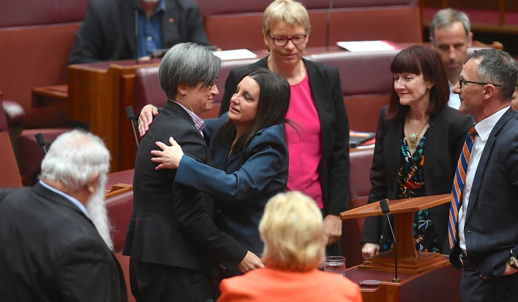 Lambie is hugged by other senators after delivering her statement. Photo: Reuters