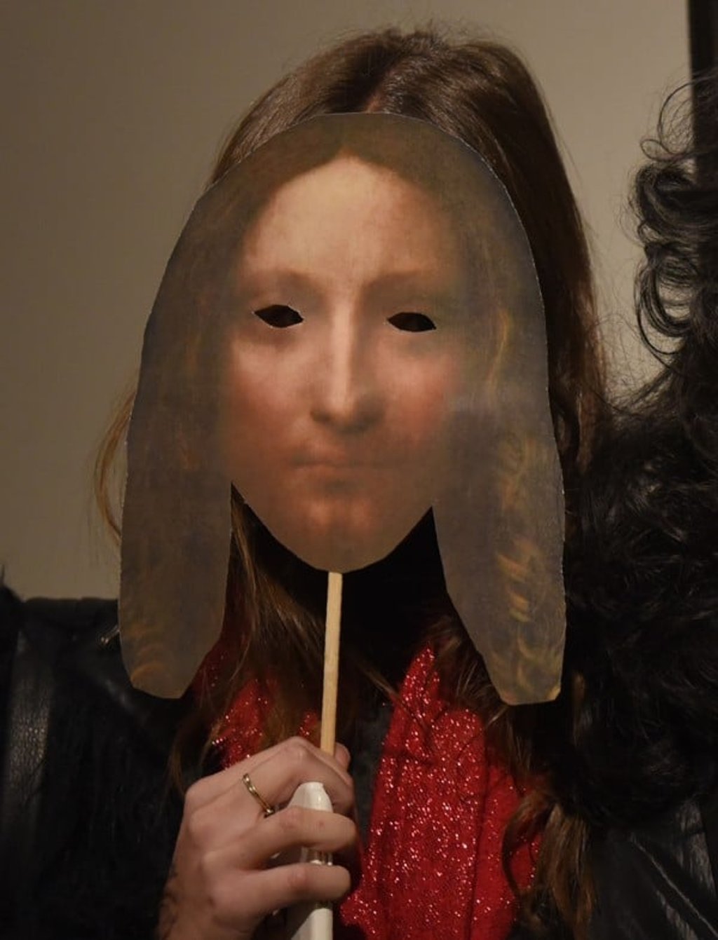 A woman holds up a paddle with the likeness of Leonardo da Vinci’s “Salvator Mundi” as she arrives at the Christie’s sale. Photo: AFP