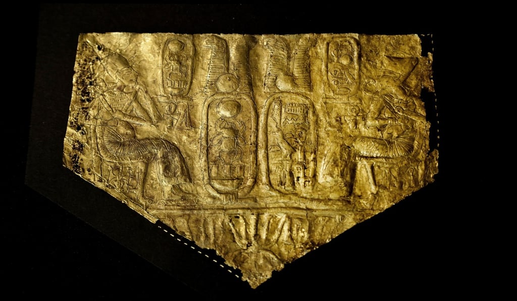 An Ancient Egyptian artefact, a gold sheet depicting Tutankhamen smiting a Nubian captive in the presence of Queen Ankhesenamun, is displayed in a glass case during the opening of the exhibition entitled Tutankhamen's Unseen Treasures marking the 115th anniversary of the Egyptian museum in Cairo. Photo: AP An Ancient Egyptian artefact, a gold sheet depicting Tutankhamen smiting a Nubian captive in the presence of Queen Ankhesenamun, is displayed in a glass case during the opening of the exhibition entitled Tutankhamen's Unseen Treasures marking the 115th anniversary of the Egyptian museum in Cairo. Photo: AP