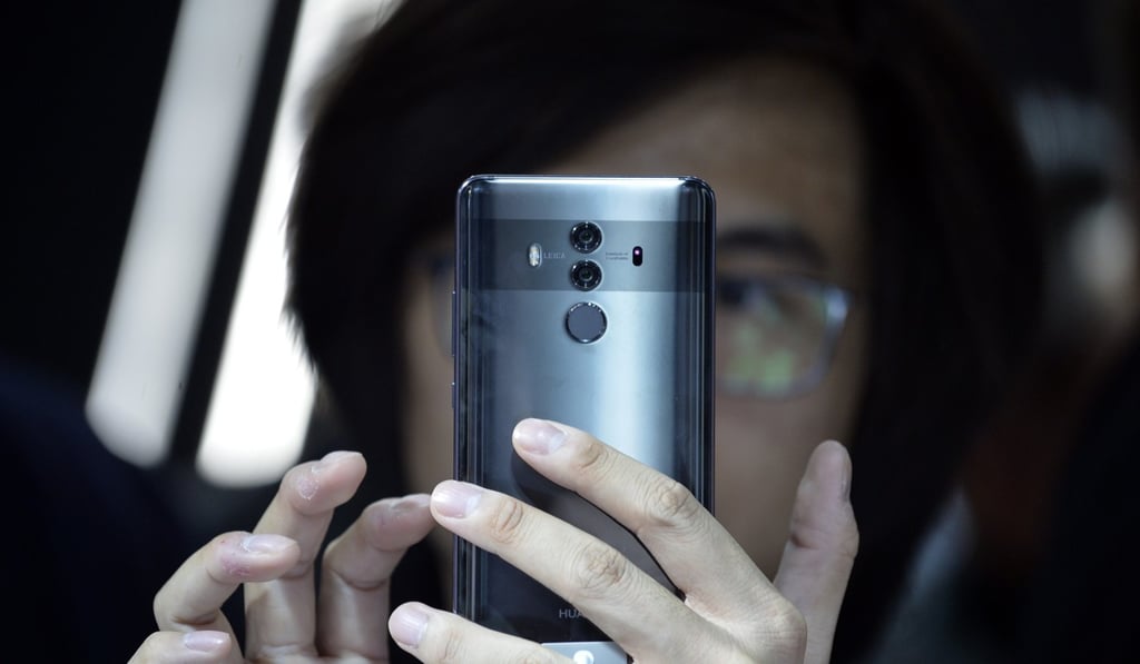 An attendee tries out the new Huawei Mate 10 Pro during the official launch event for the smartphone series in Munich on October 16. Four decades after Deng Xiaoping launched his economic reform model, which included investment in technology, Huawei is the world’s third-largest smartphone manufacturer. Photo: EPA-EFE