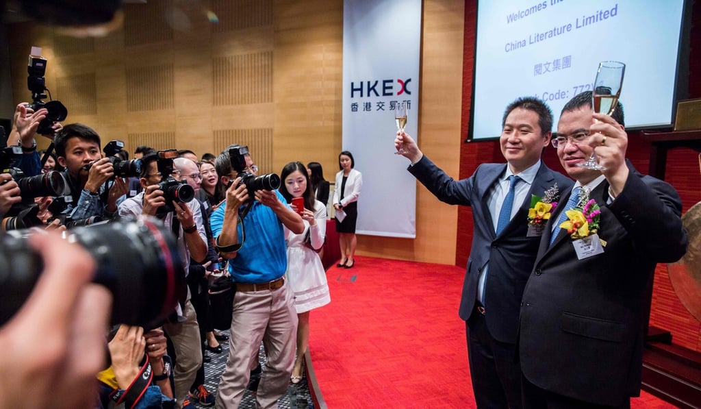 China Literature co-chief executive officers Liang Xiaodong (2nd right) and Wu Wenhui (right) toast its surge in share price on day one of trading on November 8. Photo: AFP China Literature co-chief executive officers Liang Xiaodong (2nd right) and Wu Wenhui (right) toast its surge in share price on day one of trading on November 8. Photo: AFP