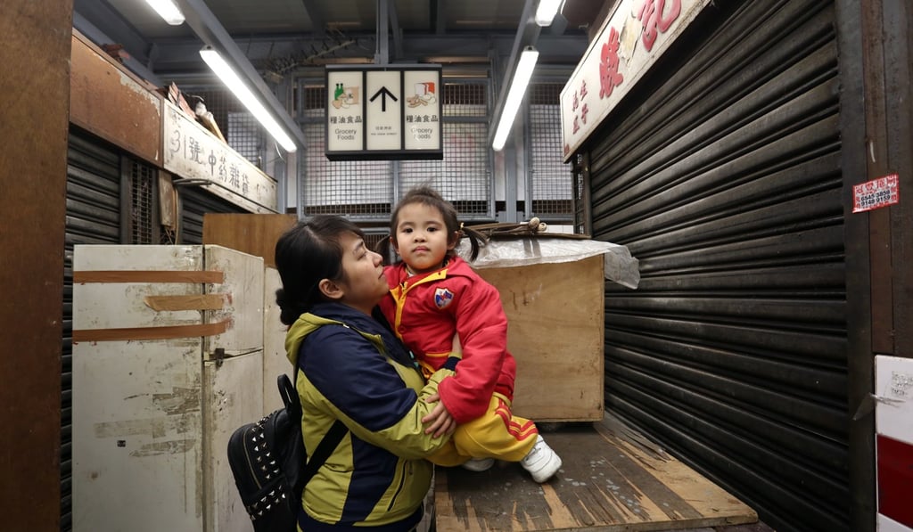 Former Vietnamese refugee Vu Thanh Thuy with her daughter Nguyen Bao Ngoi, near the jade and stone market in Sham Shui Po. Vu Thanh Thuy was conned into coming to Hong Kong in 2015 and was surviving on food vouchers a year later while waiting for the government to assess her status, but her daughter was allowed to receive an education in Hong Kong during the process. Photo: Jonathan Wong
