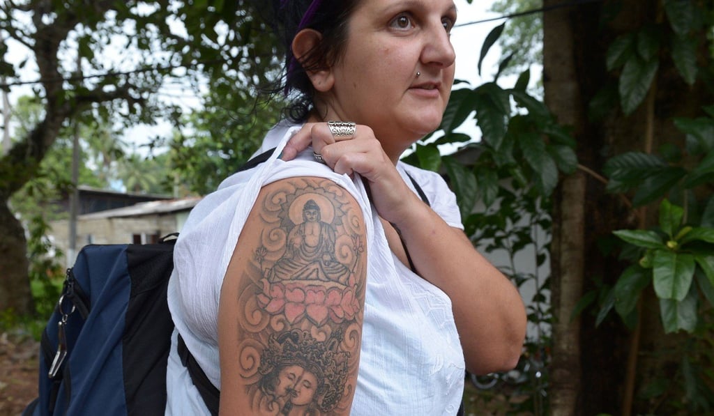 Naomi Coleman displaying a tattoo of the Buddha on her upper arm, after she was arrested at Sri Lanka's main international airport. Photo: AFP Naomi Coleman displaying a tattoo of the Buddha on her upper arm, after she was arrested at Sri Lanka's main international airport. Photo: AFP
