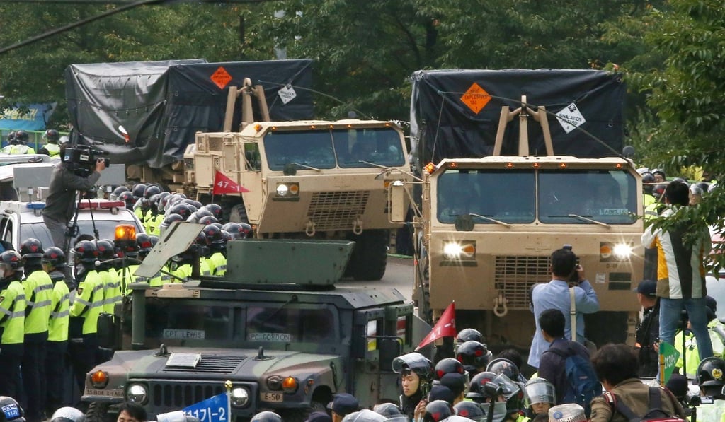 South Korean protesters try to block two US military vehicles hauling THAAD missile defence systems in Seongju. Photo: EPA