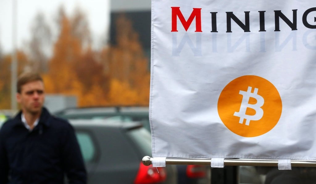 A man walks past a bitcoin mining show booth in Latvia. Photo: Reuters