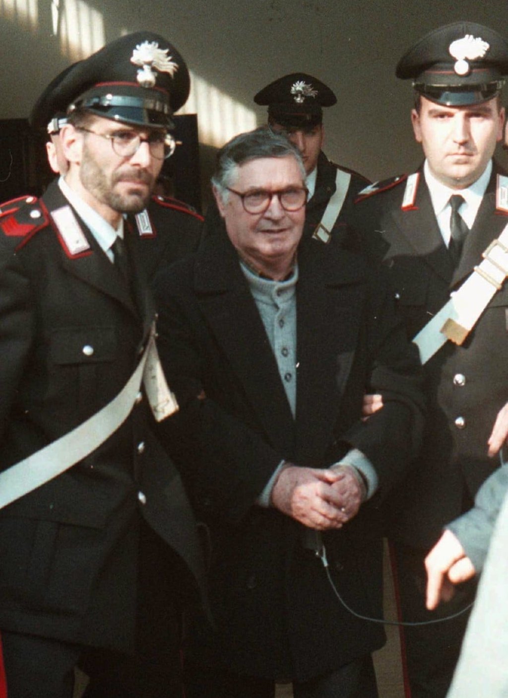 In this file photo, mafia ''boss of bosses'' Salvatore ''Toto'' Riina, centre, enters handcuffed into Bologna's bunker-courtroom, escorted by Carabinieri, Italian paramilitary police, in Bologna, Italy. Italy’s justice minister has given special permission for family bedside visits to the comatose top mafia boss who is near death. Photo: AP In this file photo, mafia ''boss of bosses'' Salvatore ''Toto'' Riina, centre, enters handcuffed into Bologna's bunker-courtroom, escorted by Carabinieri, Italian paramilitary police, in Bologna, Italy. Italy’s justice minister has given special permission for family bedside visits to the comatose top mafia boss who is near death. Photo: AP