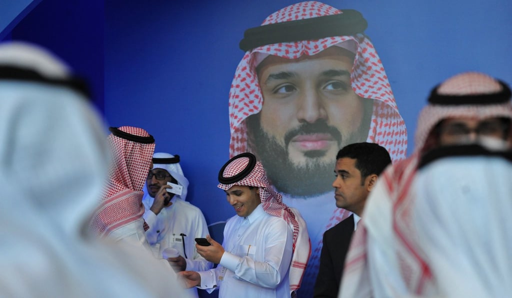 Saudi men chat in front of a poster of Saudi Crown Prince Mohammed bin Salman in Riyadh. Photo: AFP Saudi men chat in front of a poster of Saudi Crown Prince Mohammed bin Salman in Riyadh. Photo: AFP