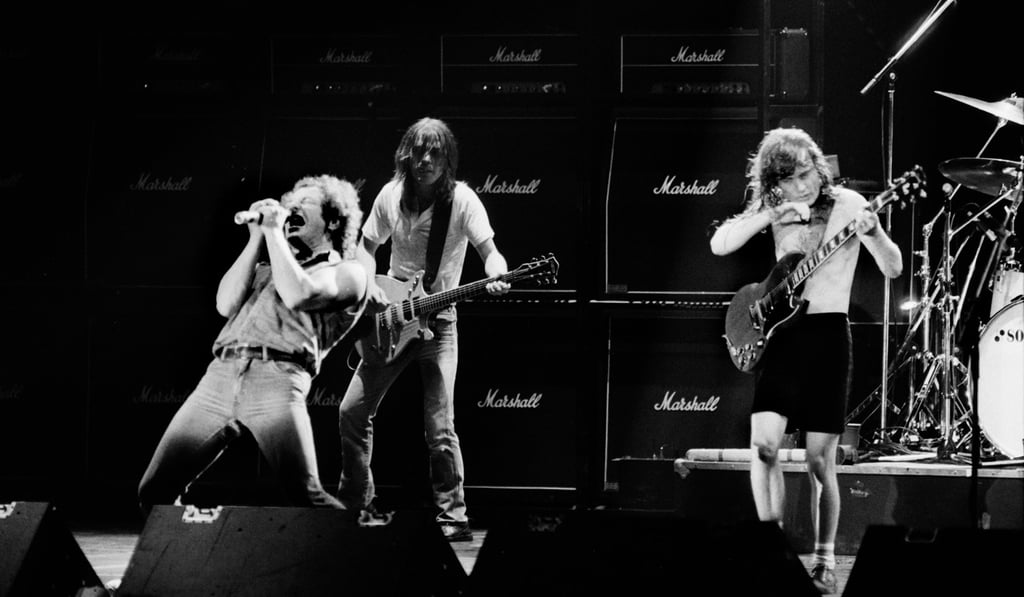 Singer Brian Johnson performs next to guitarists Malcolm Young and Angus Young of Australian legendary hard rock band AC/DC in 2984. File photo: AFP