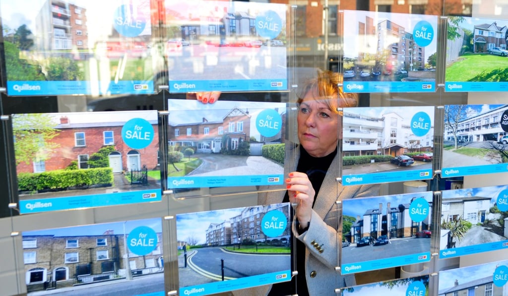 An employee of Quillsen estate agents changes the window display of available properties for sale in Dublin, Ireland, in January 2016. Ireland’s official house price index is at an eight-year high as of early November, with Dublin prices up 87 per cent since 2013. Photo: Bloomberg