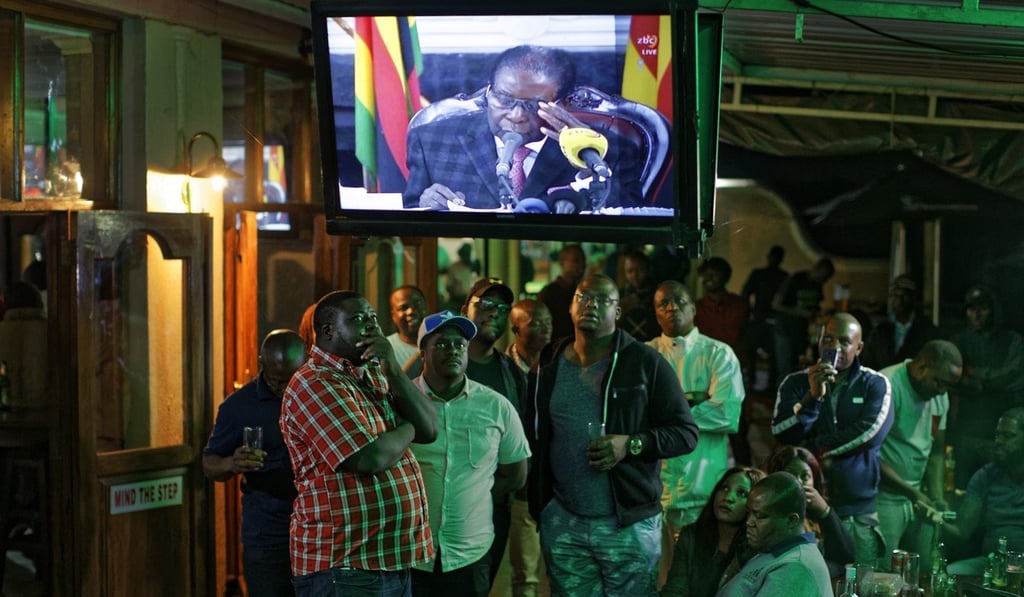 Disappointed Zimbabweans watch a televised address to the nation by President Robert Mugabe at a bar in downtown Harare, Zimbabwe, on Sunday, November 19, 2017. Mugabe refused to resign as president. Photo: AP Disappointed Zimbabweans watch a televised address to the nation by President Robert Mugabe at a bar in downtown Harare, Zimbabwe, on Sunday, November 19, 2017. Mugabe refused to resign as president. Photo: AP
