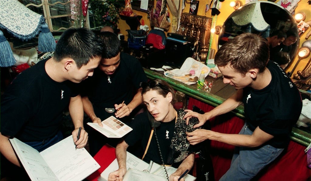 Derham (talking on the phone) working with his colleagues to prepare for a costume show that was held at the now closed Post 97 pub in Lan Kwai Fong.