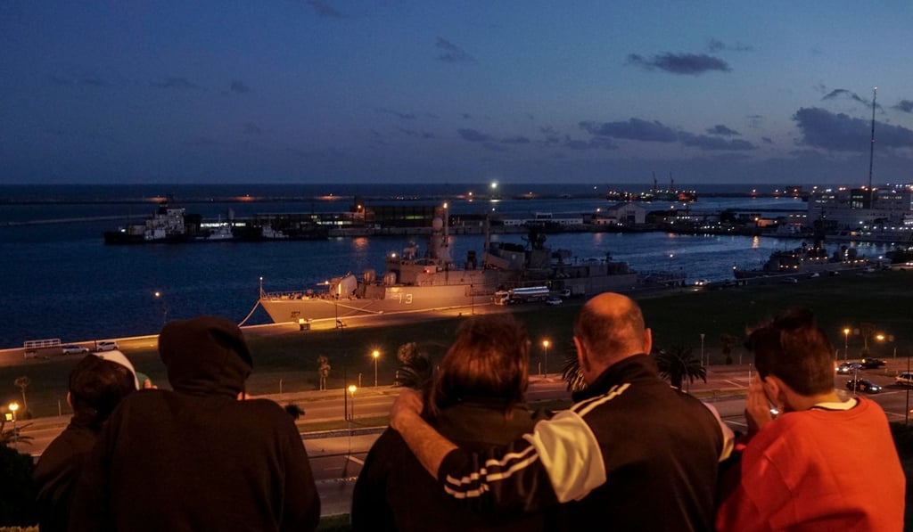 A family looks at Argentine Navy destroyer ARA Sarandi docked at Argentina's Navy base in Mar del Plata, on the Atlantic coast south of Buenos Aires, on November 20, 2017. Search vessels in the South Atlantic picked up noises on their sonar that they thought could be from a missing Argentine submarine, but those hopes have now been dashed. Photo: AFP A family looks at Argentine Navy destroyer ARA Sarandi docked at Argentina's Navy base in Mar del Plata, on the Atlantic coast south of Buenos Aires, on November 20, 2017. Search vessels in the South Atlantic picked up noises on their sonar that they thought could be from a missing Argentine submarine, but those hopes have now been dashed. Photo: AFP
