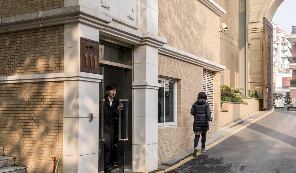 A security guard stands at the entrance to an unmarked building compound listed as an address for CEFC China Energy in Shanghai on Wednesday. Photo: AP