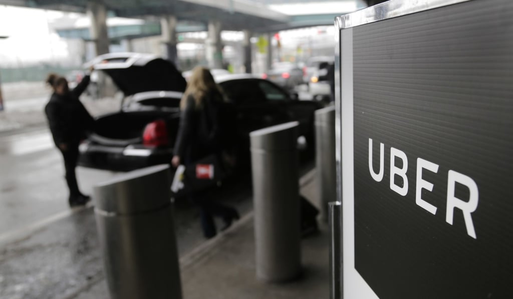 A sign marks a pick-up point for the Uber car service at LaGuardia Airport in New York. Photo: AP A sign marks a pick-up point for the Uber car service at LaGuardia Airport in New York. Photo: AP