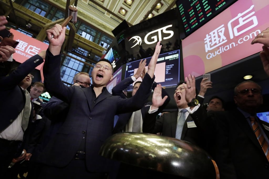 Qudian Inc’s CEO Luo Min, left, and CFO Carl Yeung celebrate with a ceremonial bell ringing during the October 18 trading debut of their company’s shares on the New York Stock Exchange. Photo: AP