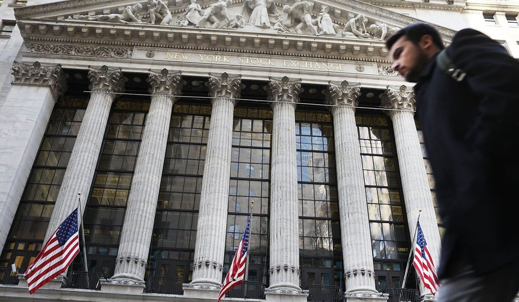 A man walks past the New York Stock Exchange on February 6, in New York City. President Donald Trump’s deregulatory efforts and pledge to enact sweeping tax cuts have boosted stock performances throughout the year, with prices rising in nine of the first 10 months of his presidency, a first for an American president. Photo: AFP