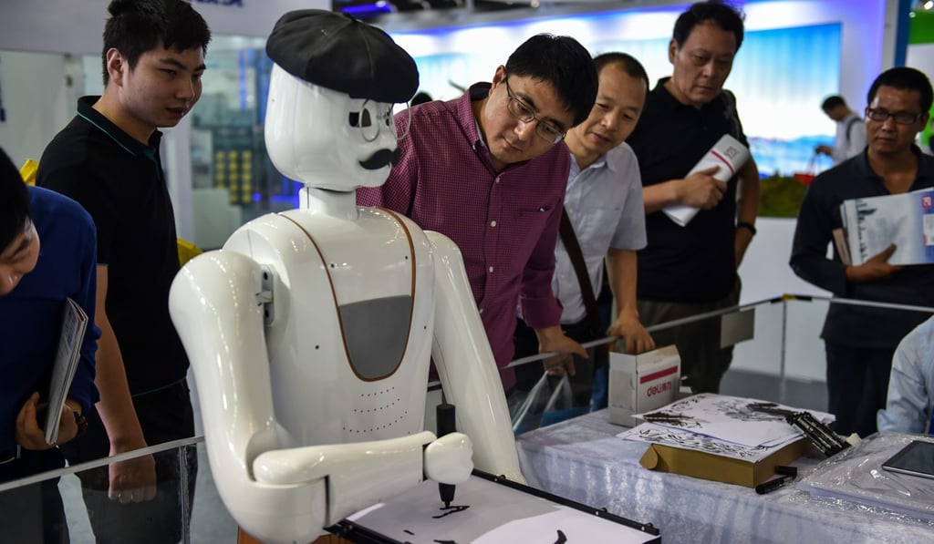 Onlookers take in a robot painting demonstration during the 19th China Hi-tech Fair in Shenzhen. Photo: Xinhua Onlookers take in a robot painting demonstration during the 19th China Hi-tech Fair in Shenzhen. Photo: Xinhua