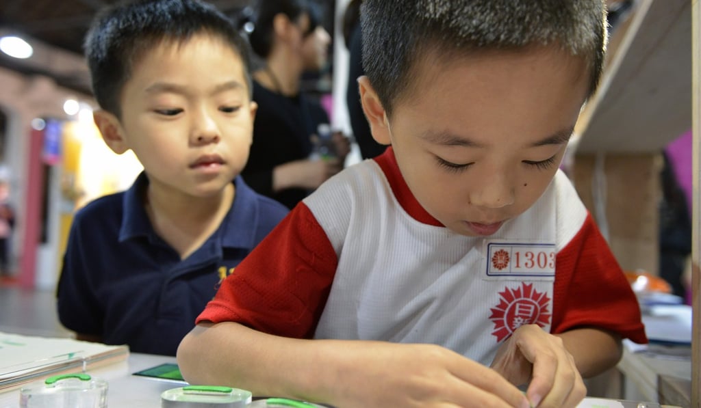 A boy stamps a traditional Chinese character at a fair in Taipei. Photo: AFP