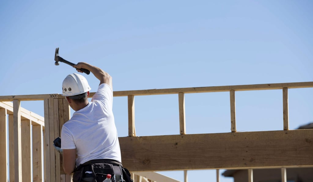 A contractor hammers the frame of a home under construction at the D R Horton Express Homes Magma Ranch housing estate in Florence, Arizona. Photo: Bloomberg A contractor hammers the frame of a home under construction at the D R Horton Express Homes Magma Ranch housing estate in Florence, Arizona. Photo: Bloomberg