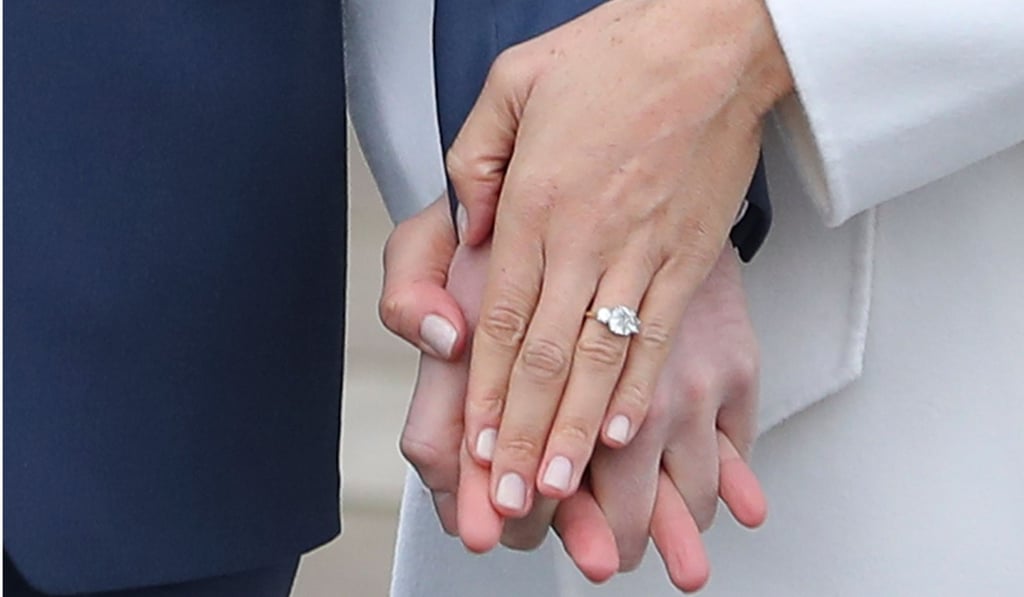 Britain's Prince Harry’s fiancée US actress Meghan Markle she shows off her engagement ring as they pose for photographers at Kensington Palace in London on Monday. Photo: AFP