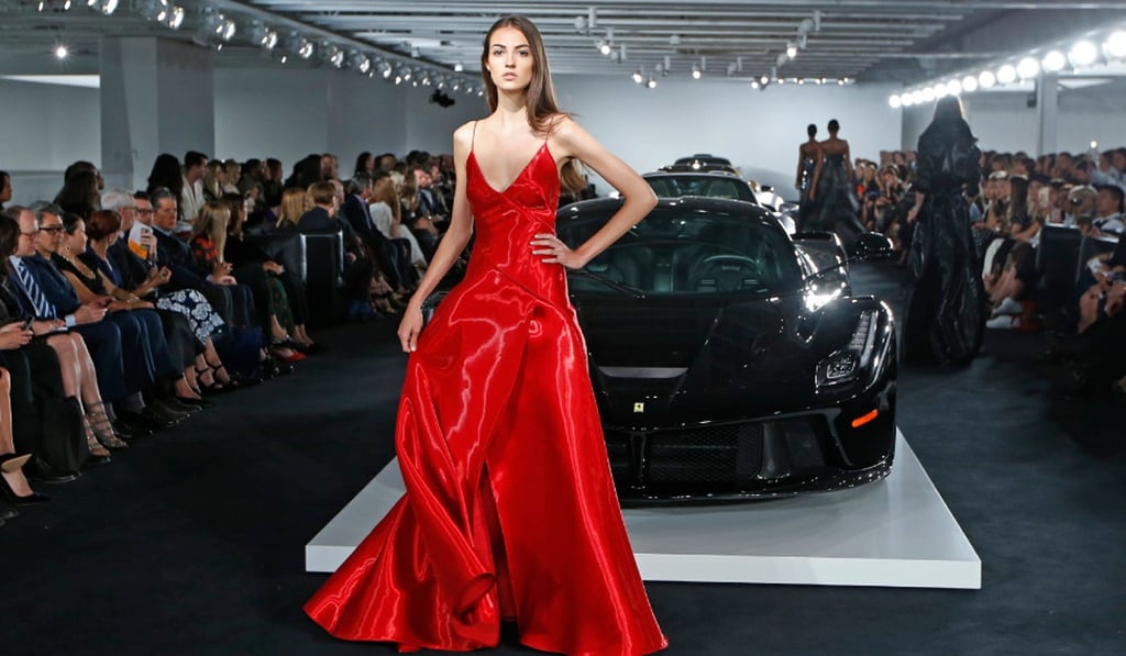 A model pauses in front of Ralph Lauren's car collection in during the autumn 2017 fashion show in his New York garage in September 2017. Photo: AP