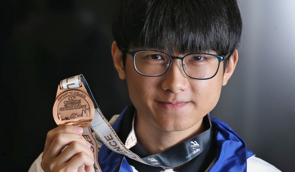 Ray Chong Tak-ki , graduate of Higher Diploma in Software Engineering, with his medal of excellence from the WorldSkills Competition in Abu Dhabi. Photo: Dickson Lee