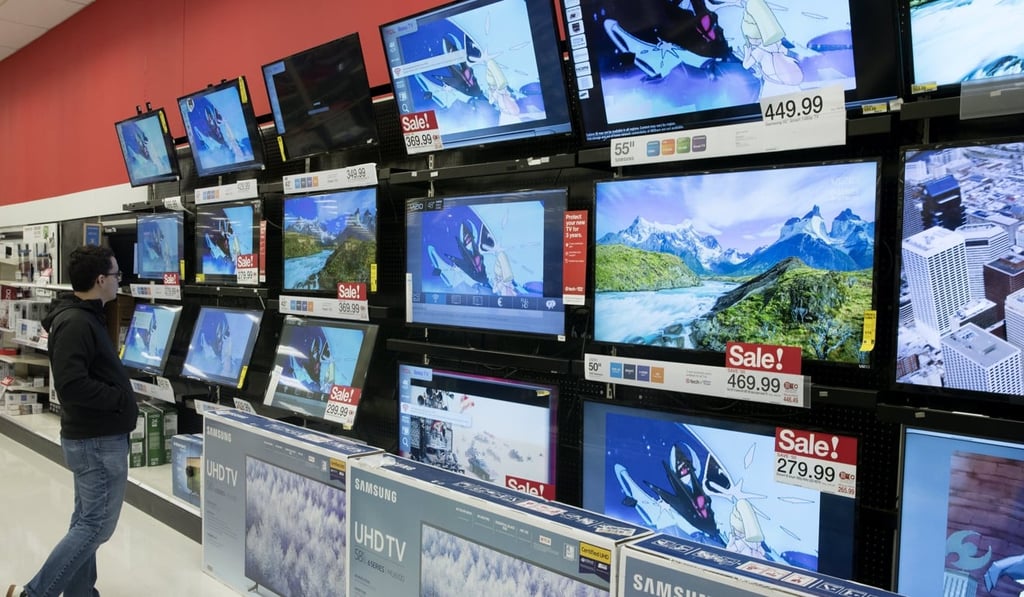 A customer looks at television sets at a Target store on Black Friday in Alexandria, Virginia. American consumer confidence hit a 17-year high. Photo: EPA-EFE