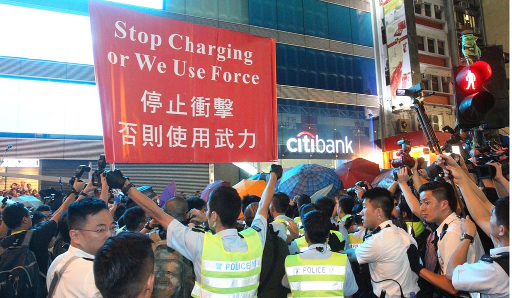 Police officers warn protesters in Mong Kok during Occupy Central, on October 17, 2014. Photo: May Tse