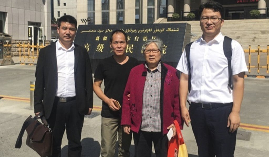 Zhou Yuan (second from left) with his mother Li Bizhen and lawyers Liu Zheng (far left) and Wang Xing outside the court on Thursday. Photo: Wang Xing