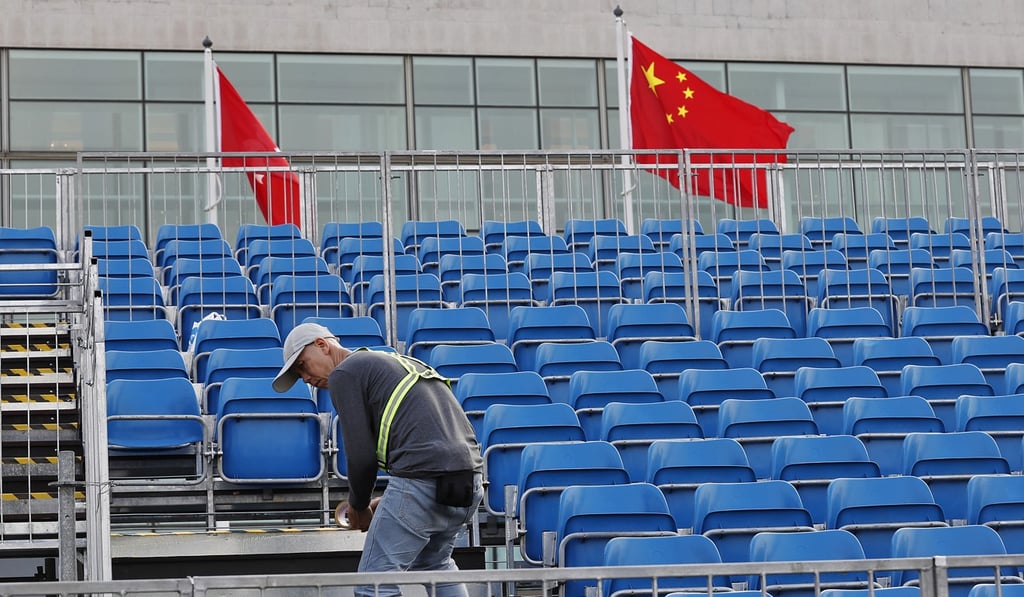 A worker keeps the grandstand clean in preparation for this weekend’s race. Photo: Edward Wong