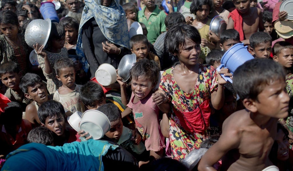 Rohingya children who fled Myanmar into neighbouring Bangladesh wait for food handouts at a refugee camp. Photo: AP