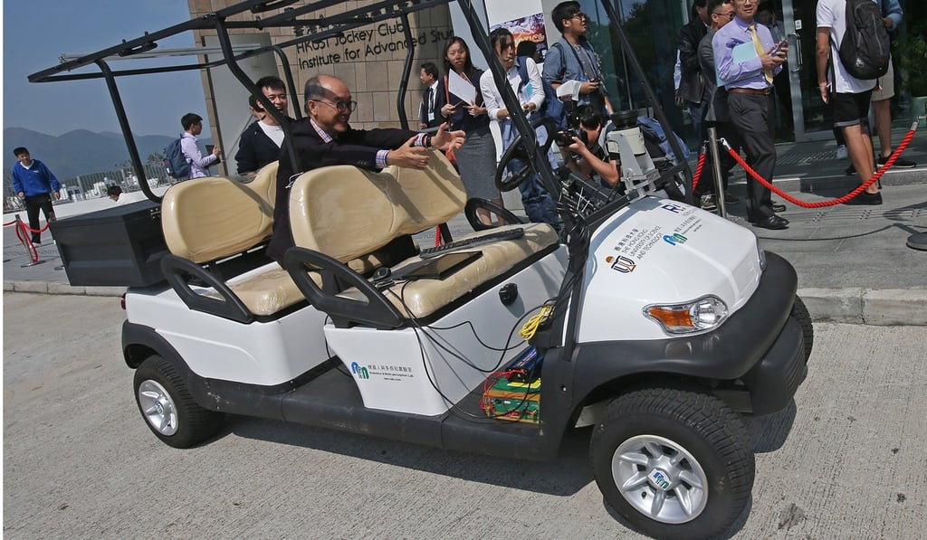 HKUST president Tony Chan Fan-cheong takes a ride on the driverless car developed by Professor Liu Ming and his team, on October 30. Photo: David Wong