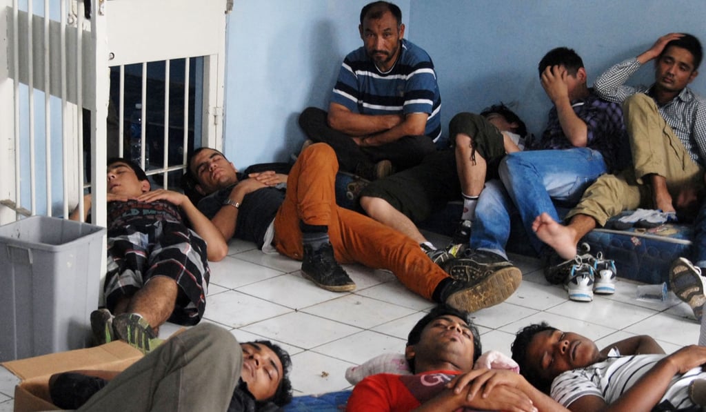 Rohingya asylum seekers and Afghan refugees at the Tangerang immigration office, Indonesia. Photo: AFP