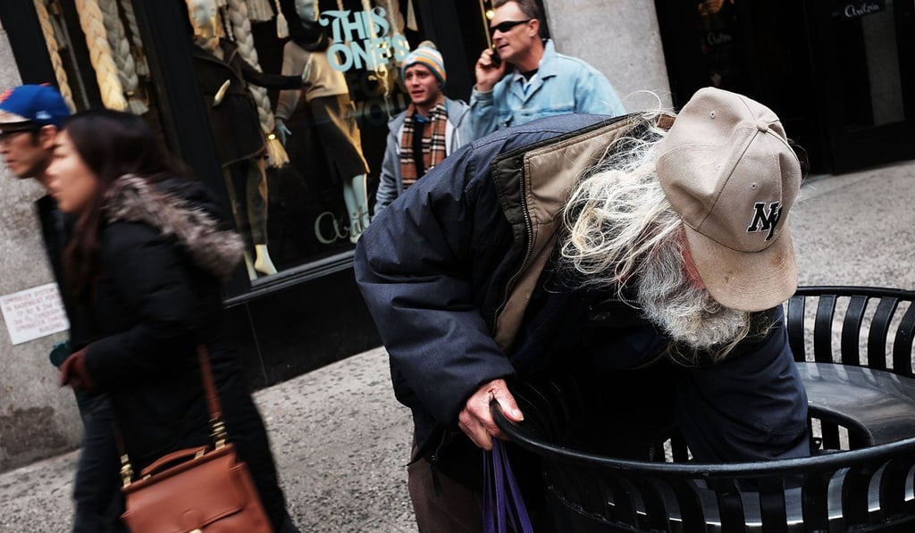 A man looks for food in a rubbish bin in New York City. Photo: AFP