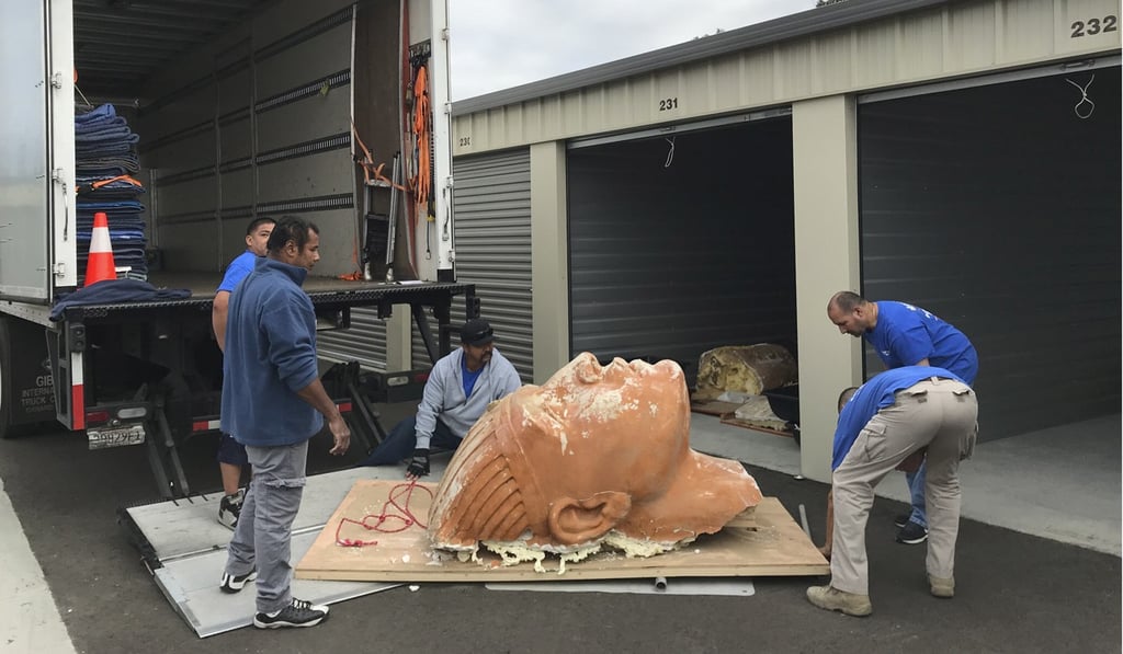 The crews moving the unearthed sphinx head. Photo: AP The crews moving the unearthed sphinx head. Photo: AP