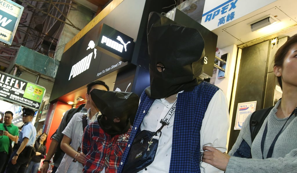 Officers arrest two women in Mong Kok after a four-year-old girl was found to have multiple bruises on her body and to be suffering from bleeding in the brain. Photo: David Wong