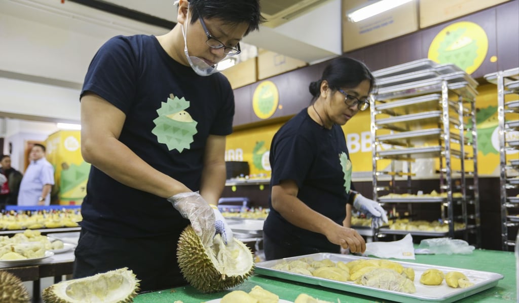DurianBB worker Colin Dung opens durians at the King Win Factory Building in Kwun Tong. Photo: Xiaomei Chen